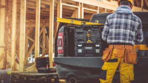 Image of a construction worker at a site using a bakkie to augment the blog article which is titled Rent to Buy Cars for Self Employed People