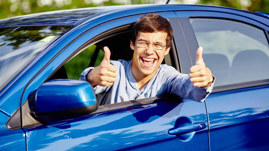 Excited young man who is augmenting the blog article titled first rent to buy car.